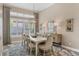 Elegant dining room with stylish chandelier, large windows, and seating for six at 4719 Cabreo Ct, Bradenton, FL 34211