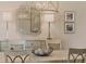 Formal dining room with stylish lighting fixtures, buffet, and elegant decor at 4719 Cabreo Ct, Bradenton, FL 34211