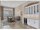 Elegant dining room with stylish chandelier, large windows, and a convenient bar area at 4719 Cabreo Ct, Bradenton, FL 34211