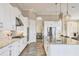 A spacious kitchen featuring white cabinetry, stainless steel appliances, and a large island at 4719 Cabreo Ct, Bradenton, FL 34211