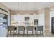 Modern kitchen featuring white cabinetry, stainless steel appliances, and a large island with seating at 4719 Cabreo Ct, Bradenton, FL 34211