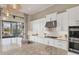 Bright kitchen features quartz counters, stainless appliances and views of the pool and patio at 4719 Cabreo Ct, Bradenton, FL 34211