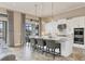 The modern kitchen features an island with seating, stainless steel appliances, and quartz countertops at 4719 Cabreo Ct, Bradenton, FL 34211