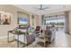 Bright living room with neutral decor, tile floors, and large windows offering scenic views at 4719 Cabreo Ct, Bradenton, FL 34211
