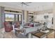 Open-concept living area boasts a ceiling fan, comfortable seating, and a view of the outdoor kitchen at 4719 Cabreo Ct, Bradenton, FL 34211