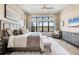 Bright main bedroom featuring a large window overlooking the waterfront view and a stylish ensuite sitting area at 4719 Cabreo Ct, Bradenton, FL 34211