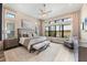 Serene main bedroom boasting large windows, stylish decor, and ample natural light at 4719 Cabreo Ct, Bradenton, FL 34211