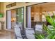 Covered patio and outdoor dining space with a view into the home's kitchen at 4719 Cabreo Ct, Bradenton, FL 34211