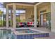 Elegant outdoor living space with a pool, spa, and covered seating area with an outdoor kitchen at 4719 Cabreo Ct, Bradenton, FL 34211