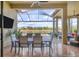Covered patio with a dining table, lake views, ceiling fan, and comfortable seating area at 4719 Cabreo Ct, Bradenton, FL 34211
