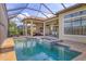 Inviting screened-in pool and spa area with outdoor kitchen perfect for entertaining at 4719 Cabreo Ct, Bradenton, FL 34211