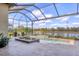 Screened-in patio featuring a built-in jacuzzi and lake views at 4719 Cabreo Ct, Bradenton, FL 34211