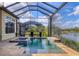 Tranquil screened pool with views of the lake, a built-in spa, and a spacious deck for relaxation at 4719 Cabreo Ct, Bradenton, FL 34211