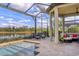 Beautiful screened-in pool and hot tub with comfortable lounge chairs and views of the lake at 4719 Cabreo Ct, Bradenton, FL 34211