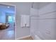 View into the bathroom from a sitting room with the white shower and tiled floor at 4907 Torrey Pines Run, Bradenton, FL 34211