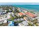 Aerial view of the property with the beach in the background and lush tropical landscaping around the property at 520 Spring Ave # A, Anna Maria, FL 34216