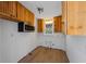 Unfinished kitchen featuring wood cabinets, stainless steel microwave, and a window for natural light at 520 Spring Ave # A, Anna Maria, FL 34216