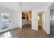 Bright living room with new flooring, open to the unfinished kitchen and bathroom with backyard access at 520 Spring Ave # A, Anna Maria, FL 34216