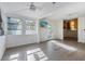 Bright and airy living room with modern flooring and ceiling fans at 520 Spring Ave # A, Anna Maria, FL 34216