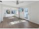 Bright, spacious living area featuring modern floors, a ceiling fan, and access to a sunroom at 520 Spring Ave # A, Anna Maria, FL 34216