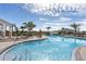 Expansive pool deck with lounge chairs and umbrella tables at 550 157Th E Ct, Bradenton, FL 34212