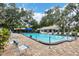 Community pool with ample seating and shaded areas surrounded by mature trees at 5616 Garden Lakes Majestic, Bradenton, FL 34203