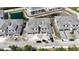 New construction shows modern townhomes with gray roofing near a pond in a developing community at 5628 Summit Point Cir # 103, Bradenton, FL 34210