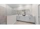 Bright bathroom with double vanity, white cabinets, neutral tiled floor, and an open walk-in shower with glass divider at 5628 Summit Point Cir # 103, Bradenton, FL 34210