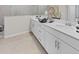 Elegant bathroom featuring a double sink vanity with white cabinets and a separate tiled shower area at 5628 Summit Point Cir # 103, Bradenton, FL 34210
