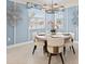 Cozy dining room featuring a round table with elegant chairs, stylish lighting, and soft blue walls at 5628 Summit Point Cir # 103, Bradenton, FL 34210
