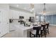 Bright kitchen with a large white island, stainless steel appliances, and stylish pendant lighting over a breakfast bar at 5628 Summit Point Cir # 103, Bradenton, FL 34210
