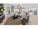 Cozy living room with a large sectional sofa, stylish decor, and easy access to the kitchen and balcony at 5628 Summit Point Cir # 103, Bradenton, FL 34210
