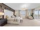 Stunning main bedroom featuring a stylish accent wall, luxurious king bed, and access to a private balcony at 5628 Summit Point Cir # 103, Bradenton, FL 34210