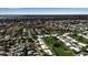 Overhead view of a neighborhood featuring well-maintained homes and a large body of water in the distance at 6608 13Th Avenue W Dr, Bradenton, FL 34209