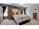 Comfortable bedroom with a king bed, built-in storage, and soft carpet flooring at 6608 13Th Avenue W Dr, Bradenton, FL 34209