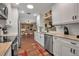 Bright kitchen featuring white cabinetry, stainless steel appliances, and a view into the dining room at 6608 13Th Avenue W Dr, Bradenton, FL 34209