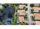 Aerial view of a single-Gathering home featuring a backyard pool, set against a scenic lake backdrop at 6961 Scrub Jay Dr, Sarasota, FL 34241