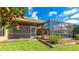Lush backyard with a screened-in lanai and well-maintained landscaping, perfect for outdoor enjoyment at 6961 Scrub Jay Dr, Sarasota, FL 34241
