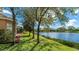 Picturesque backyard featuring mature trees and a tranquil lake view, ideal for relaxation at 6961 Scrub Jay Dr, Sarasota, FL 34241