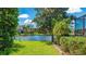 Captivating backyard view with a lake, lush greenery, mature trees, and serene landscaping at 6961 Scrub Jay Dr, Sarasota, FL 34241