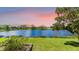 Scenic view of a backyard overlooking a tranquil lake with lush greenery, creating a serene and inviting atmosphere at 6961 Scrub Jay Dr, Sarasota, FL 34241