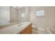 Neutral bathroom featuring a large mirror, single sink, and tile flooring at 6961 Scrub Jay Dr, Sarasota, FL 34241