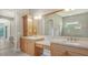 Bathroom with a double sink vanity, granite countertops and lots of storage at 6961 Scrub Jay Dr, Sarasota, FL 34241