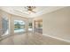 Bright bedroom with ceiling fan and access to the pool area at 6961 Scrub Jay Dr, Sarasota, FL 34241