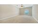 Bright bedroom with a ceiling fan, large window with blinds, and neutral wall color complemented by carpet flooring at 6961 Scrub Jay Dr, Sarasota, FL 34241
