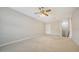 Large, carpeted bonus room with a ceiling fan, ready for customization and entertainment at 6961 Scrub Jay Dr, Sarasota, FL 34241