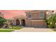 Charming two-story home with an attached two-car garage and arched entryway at 6961 Scrub Jay Dr, Sarasota, FL 34241