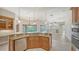 Open concept kitchen with breakfast bar and view to the living room and pool at 6961 Scrub Jay Dr, Sarasota, FL 34241