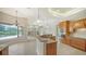 Bright kitchen with granite counters, wooden cabinets, and a view of the pool at 6961 Scrub Jay Dr, Sarasota, FL 34241