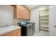 Functional laundry room with modern appliances, ample storage, and utility sink at 6961 Scrub Jay Dr, Sarasota, FL 34241